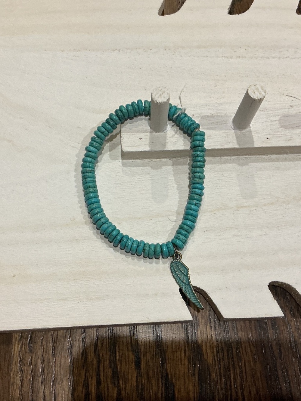 A teal wing bracelet